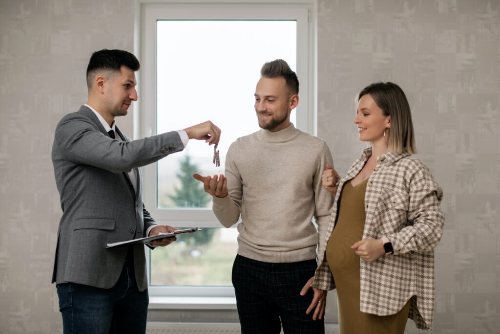 This is an image of a valley realty real estate agent handing the keys to their client